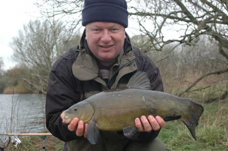 Phil Harvey cradles a PB Tench of 6-10lb